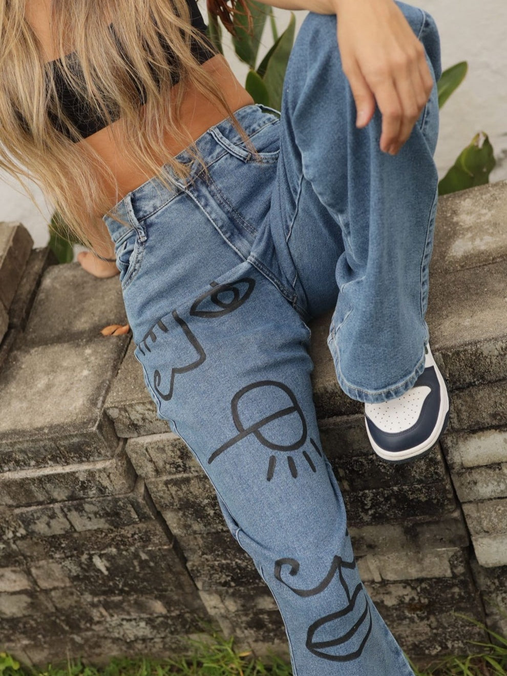 Stylish Blue Jeans Featuring Artistic Black - Ink Drawings