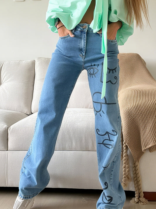 Stylish Blue Jeans Featuring Artistic Black - Ink Drawings